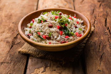 Dapde Pohe is a typical Maharashtrian breakfast, made with thin variety of poha and fresh coconut with chilli, peanuts and nuts. served in a bowl or plate. selective focus