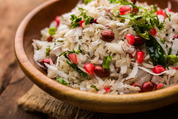 Dapde Pohe is a typical Maharashtrian breakfast, made with thin variety of poha and fresh coconut with chilli, peanuts and nuts. served in a bowl or plate. selective focus