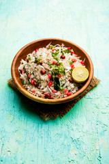Dapde Pohe is a typical Maharashtrian breakfast, made with thin variety of poha and fresh coconut with chilli, peanuts and nuts. served in a bowl or plate. selective focus