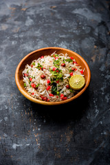 Dapde Pohe is a typical Maharashtrian breakfast, made with thin variety of poha and fresh coconut with chilli, peanuts and nuts. served in a bowl or plate. selective focus