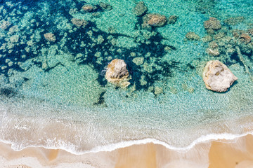 Obraz premium Aerial view of beautiful rocky coastline with turquoise sea water..