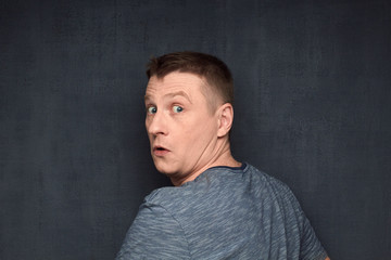 Portrait of confused man taken by surprise