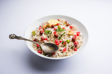Dapde Pohe is a typical Maharashtrian breakfast, made with thin variety of poha and fresh coconut with chilli, peanuts and nuts. served in a bowl or plate. selective focus