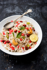 Dapde Pohe is a typical Maharashtrian breakfast, made with thin variety of poha and fresh coconut with chilli, peanuts and nuts. served in a bowl or plate. selective focus