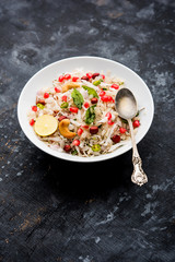 Dapde Pohe is a typical Maharashtrian breakfast, made with thin variety of poha and fresh coconut with chilli, peanuts and nuts. served in a bowl or plate. selective focus