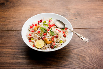 Dapde Pohe is a typical Maharashtrian breakfast, made with thin variety of poha and fresh coconut with chilli, peanuts and nuts. served in a bowl or plate. selective focus