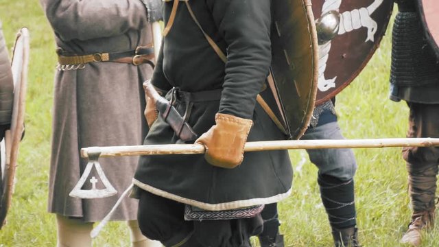 Axe warrior getting ready for battle. Medieval soldiers in full armor, vikings