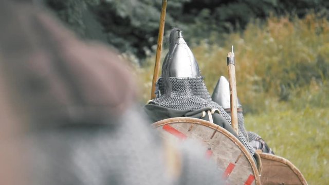 Knight warriors marching forward. Medieval soldiers in full plate armor