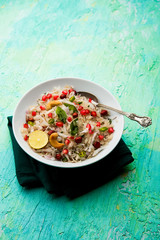 Dapde Pohe is a typical Maharashtrian breakfast, made with thin variety of poha and fresh coconut with chilli, peanuts and nuts. served in a bowl or plate. selective focus