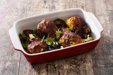 Roasted tandoori chicken with basmati rice on wooden table