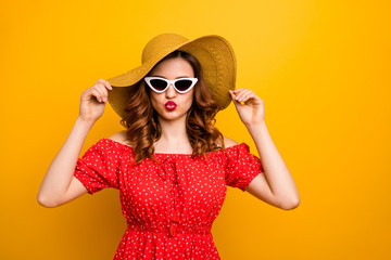 Coquette lady sending air kiss to handsome guy at pool party wear red dress specs hat isolated yellow background