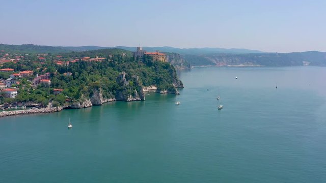Sea shore near Trieste, Italy. Aerial drone view of ruines of the old fortress of Duino Castle.