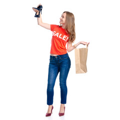 Woman in shirt holding high heels shoes and bag package sale shopping fashion smiling happiness on white background isolation