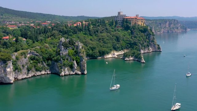 Sea shore near Trieste, Italy. Aerial drone view of ruines of the old fortress of Duino Castle.