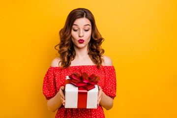 Pretty foxy lady hold arms big giftbox desire to open it wear dress isolated yellow background