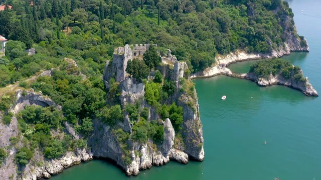 Sea shore near Trieste, Italy. Aerial drone view of ruines of the old fortress of Duino Castle.