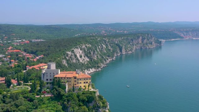 Sea shore near Trieste, Italy. Aerial drone view of ruines of the old fortress of Duino Castle.