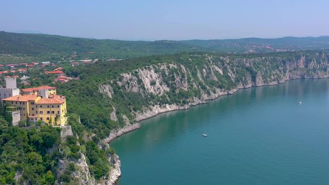 Sea shore near Trieste, Italy. Aerial drone view of ruines of the old fortress of Duino Castle.