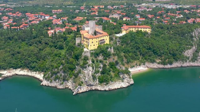 Sea shore near Trieste, Italy. Aerial drone view of ruines of the old fortress of Duino Castle.