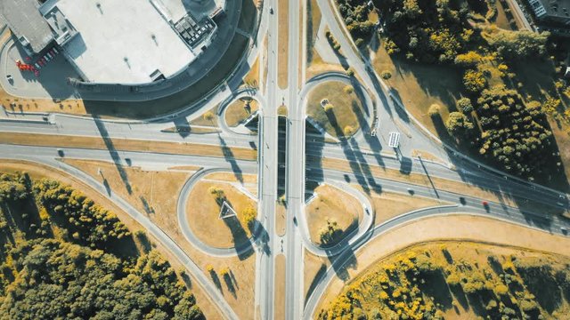 Highway cloverleaf interchange ramps, heavy traffic, aerial hyperlapse