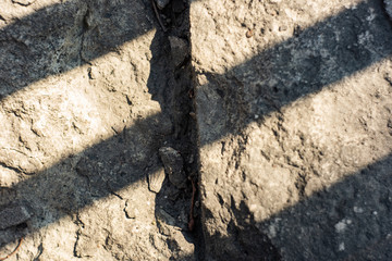 Grunge stone surface with diagonal shadow lines