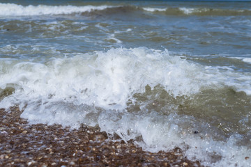 The wave comes to shore from the shell rock to the sea.