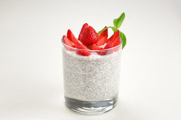 Chia pudding with strawberry and mint on a white background. Space for text or design.