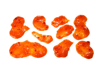 Orange spicy sauce splashes isolated on white background.