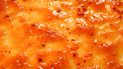 Orange sauce splashes as a background.