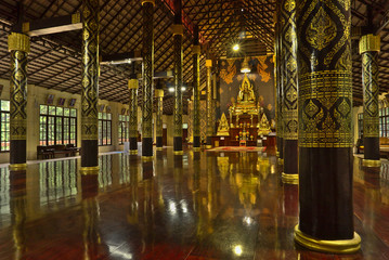 Chantaburi, Thailand - May 6, 2018 : Gold buddha statues inside wooden temple (Wat khao banchob) interior