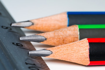 close-up photo of crayons and linear on white surface
