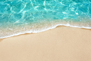 Naklejka na ściany i meble Soft blue ocean wave or clear sea on clean sandy beach summer concept