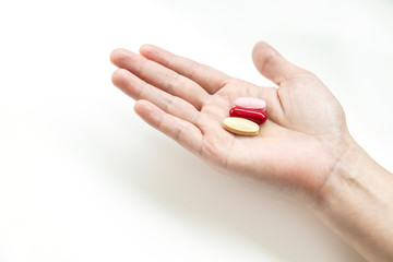 Vitamins supplements on woman hand,