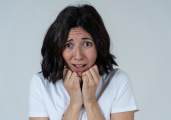 Portrait of a young attractive woman looking scared and shocked.Human expressions and emotions