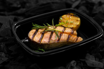 Close up of fresh cooked fish with rosemary in box