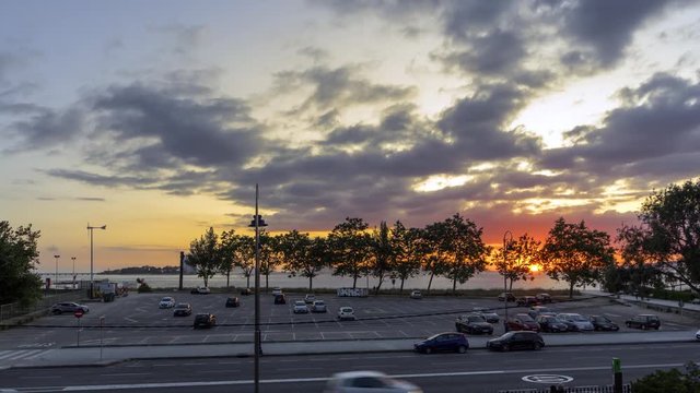 4k video of a sunset on the beach of samil in vigo galicia. You see the parking lot and behind you can see the Cies Islands