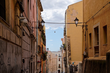 Typical row houses in Cagliari in Italy (Sardinia) with zipline and hanging basket between the windows.