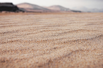 Arena  de playa al atardecer 
