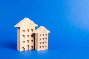 Fototapeta na wymiar Two residential buildings stands on a blue background. The concept of buying and selling real estate, renting. Search for a Apartment house. Affordable housing, credit and loans. place for text