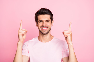 Close-up portrait of his he nice attractive cheerful cheery confident guy pointing two forefingers up ad isolated over pink pastel background