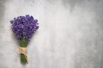Lavender flowers bouquet on gray background. Copy space, top view. Summer background. Copy space