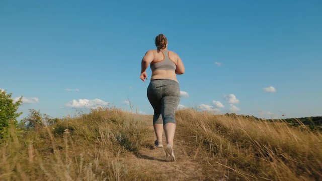 Overweight girl runs up the hill