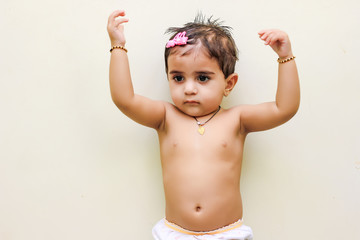 Obraz premium cute Indian baby girl playing at home