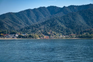 View of the famous Torii Gate from the ferry boat going to Miyajima Island from Hiroshima, Japan. Miyajima Island is a Holi Shinto Shrine, listed as an Unesco World Heritage Site.