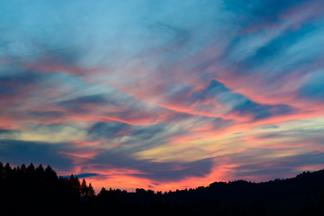 Sunset and stormy clouds over fields and hills in Pieniny Mountains, Poland