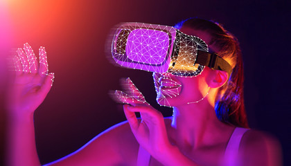 Young woman wearing VR headset using futuristic interface