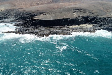 dawn between desert mountains and cliffs almost without vegetation with the Atlantic Ocean imposing
