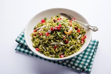 Hariyali Poha / Green Masala Pohe or flattened rice served in a bowl, selective focus