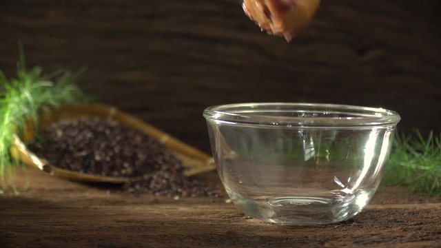 Close up of boiled rice berry in bowl on wooden table. Rice berry on background. Food and healthy concept.