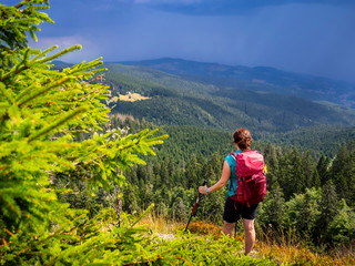 Women hiker looking at view of mountain landscape at Col de la Schlucht In the Vosges, Alsace, France